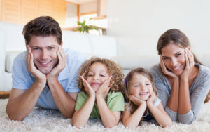 Happy Family Laying On Carpet