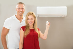 Couple Standing By A Ductless Mini Split
