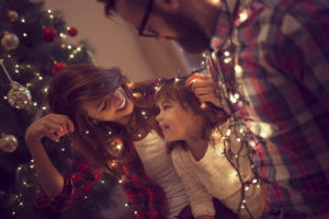 Family Having Fun With Christmas Tree Lights
