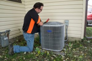 Repairman Working On Unit