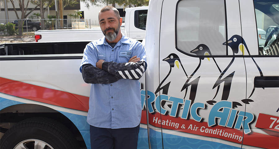 Man Leaning Against Arctic Air Truck